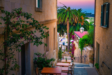 Fototapeta na wymiar Ambiance street and street cafe at dawn, Hvar, Dalmatia, Croatia