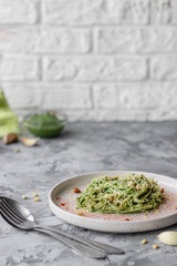 Green pasta with avocado, spinach and pine nuts