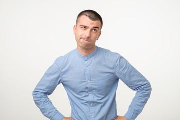 Thoughtful hispanic young man trying to fina a right solution generating idea