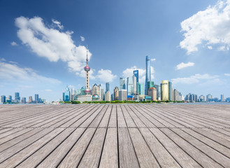 Empty wooden footpath front of shanghai city skyline