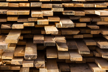 Stacked lumber background. Folded wood. Close-up cross section of board.
