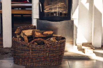 Composition, firewood, stove items, basket. real fireplace filled with firewood.