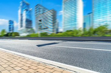 cityscape and skyline of shanghai from empty asphalt road.