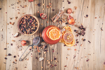 Fruit tea with cinnamon and dried berries in cup - teacup on wooden table.