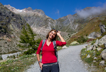 Naklejka na ściany i meble Woman trekking in the mountains