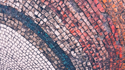 Multicolored old mosaic of small stones