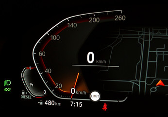 Fototapeta premium Side view of modern car dashboard with speedometer, fuel gauge indicator, fuel range, parking and low beam lights icon. Close up of petrol diesel level showing on fully digital car instrument panel.