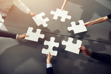 Teamwork of partners. Concept of integration and startup with puzzle pieces