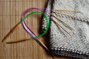 circular knitting needles lie next to the beaches.