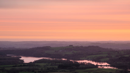 Epic Peak District Winter landscape of view from top of Hen Cloud over countryside and towards Tittesworth Reservoir