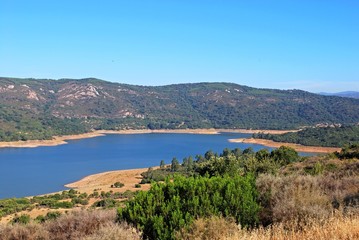 Fototapeta na wymiar View across the lake and surrounding countryside (Embalse de Guadarranque), Castillo de Castellar, Spain.