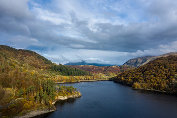 Fototapeta premium Stunning aerial drone landscape image of glorious vibrant Autumn Fall sun over Thirlmere in Lake District