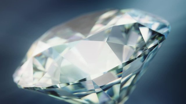 Close up of a rotating cut diamond against a blue background. 3D Rendered