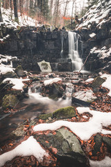 small waterfall with silky water in the mountains