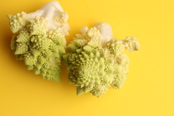 two pieces of romanesco vegetable in color background
