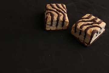 small chocolate cakes in color background