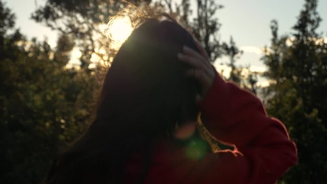 headshot of girl as she looks into camera at sunset in Hawaiian forest