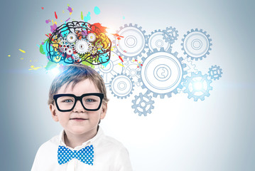 Little boy in glasses brainstorming