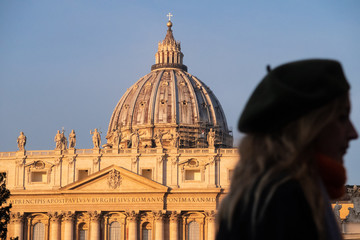 Fototapeta na wymiar Rome, Italy - Jan 3, 2020: silhouette of a female tourist near the St. Peters Basilica Vatican City, UNESCO World Heritage Site, Rome, Lazio, Italy, Europe