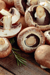 Fresh brown mushrooms champignon on a old wooden table.