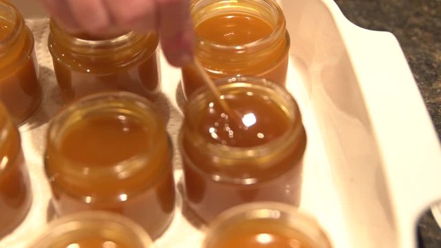 CBD and THC infused salve ointment cream being stirred. Camera on gimbal pulling back.