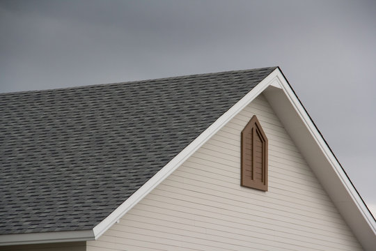 roof shingle of house with dark cloud and sky in rainy season.