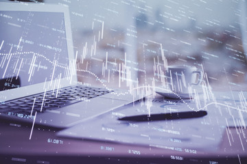 Forex graph hologram on table with computer background. Double exposure. Concept of financial markets.