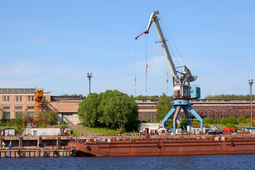 Cranes operate in river port. Cargo port on river.