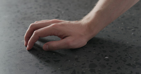 young man hand finger tap on terrazzo countertop