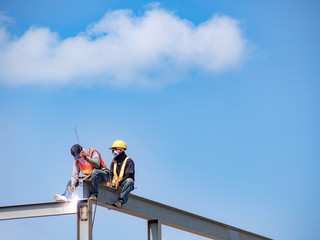Builder welding on high-rise steel frame