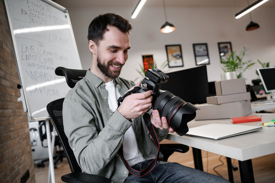 Photographer with camera in office. Young small business owner, selling online on a website. Online Sales, E-Commerce, Online Business, with postal parcel, selling online, delivery concept.