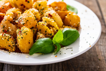 Pasta with pesto sauce on wooden table