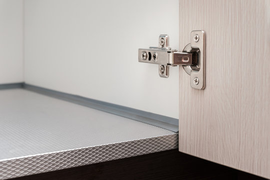 detail of concealed hinge on cabinet door, furniture fitting hardware for cupboard or wardrobe
