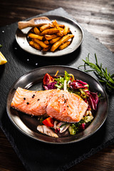 Roasted salmon with french fries and vegetable salad