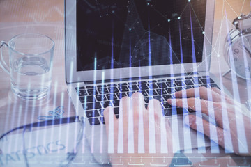 Multi exposure of market chart with man working on computer on background. Concept of financial analysis.