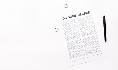 Divorce decree law document, engagement rings and pen on white