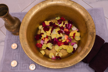 copper bowl with rose petals and copper jar for spa procedure