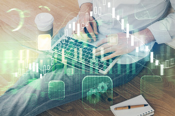 Forex graph with businessman working on computer in office on background. Concept of analysis. Double exposure.