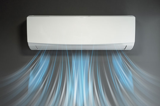 White air conditioning and a stream of fresh cold air on a background of a gray wall. The concept of heat, cool air, cooling, freshness.