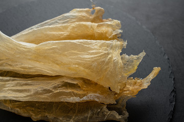 Traditional health nourishing food Maw, catfish glue on black slate tray