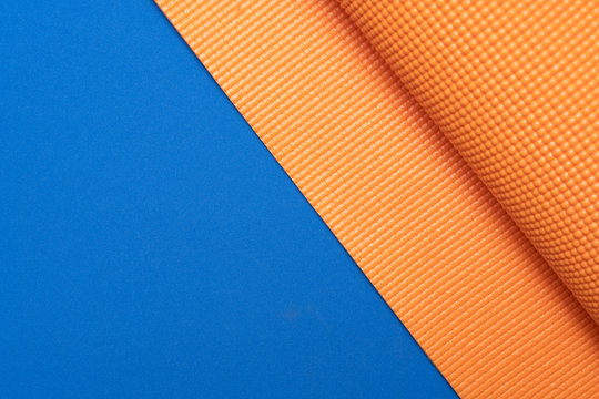 Close Up Of Yoga Mat On The Blue Table Background, Sport And Healthy Concept