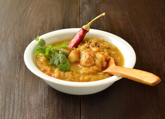 Dal, red lentil soup with turmeric, garlic, chili and cilantro. Indian food.