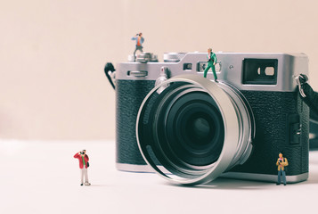 Miniature group of people photographer figures with camera, art photography concept