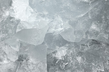 Pieces of crushed white ice glass cracks background texture. close-up frozen water