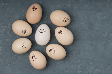 Different emotions eggs on concrete background. Easter concept