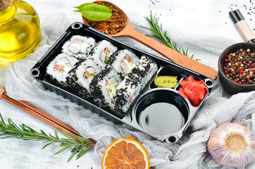 Food delivery. Sushi rolls with caviar and crab. Soy sauce, wasabi. Top view. free space for your text. Asian cuisine.
