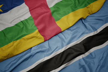 waving colorful flag of botswana and national flag of central african republic.