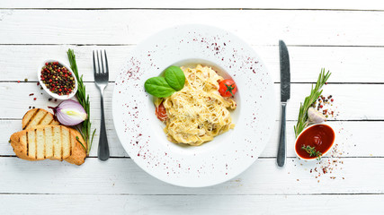 Italian traditional pasta with parmesan cheese and tomatoes. Top view. Free copy space.