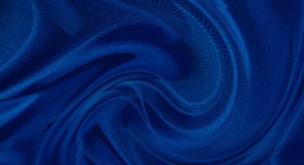 Fototapeta na wymiar abstract fabric background. waves folds of fabric dark blue color trend 2020