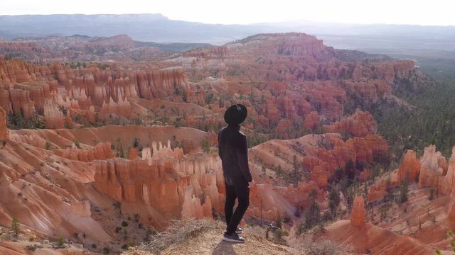 Tourist with black clothes look at hoodoos in Bryce Canyon National Park in Utah, United States of America